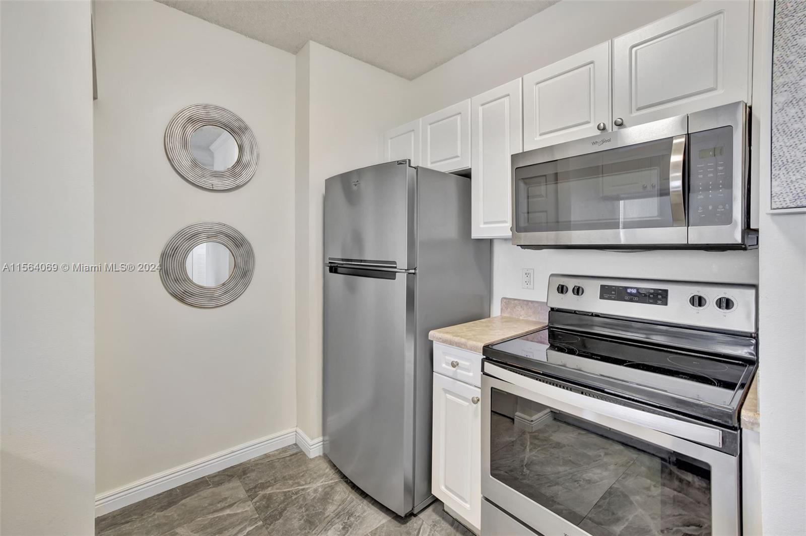 17150 North Bay Road, Unit 2216 Sunny Isles Beach, FL 33160 - Photo 15 of 46 a stove top oven sitting inside of a kitchen