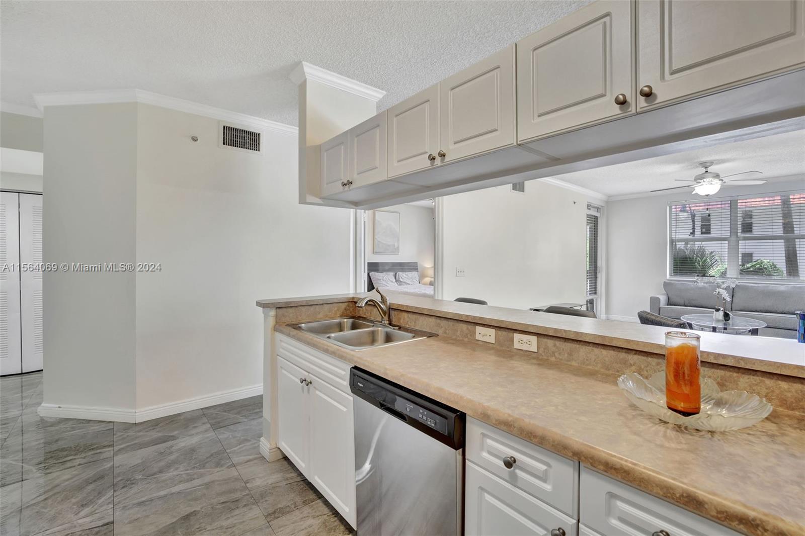 17150 North Bay Road, Unit 2216 Sunny Isles Beach, FL 33160 - Photo 16 of 46 a kitchen with a sink and cabinets