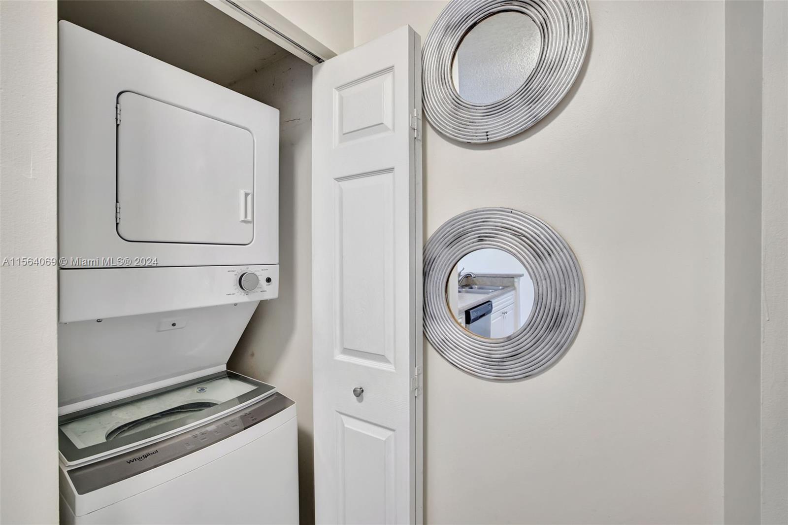 17150 North Bay Road, Unit 2216 Sunny Isles Beach, FL 33160 - Photo 17 of 46 a utility room with dryer and washer