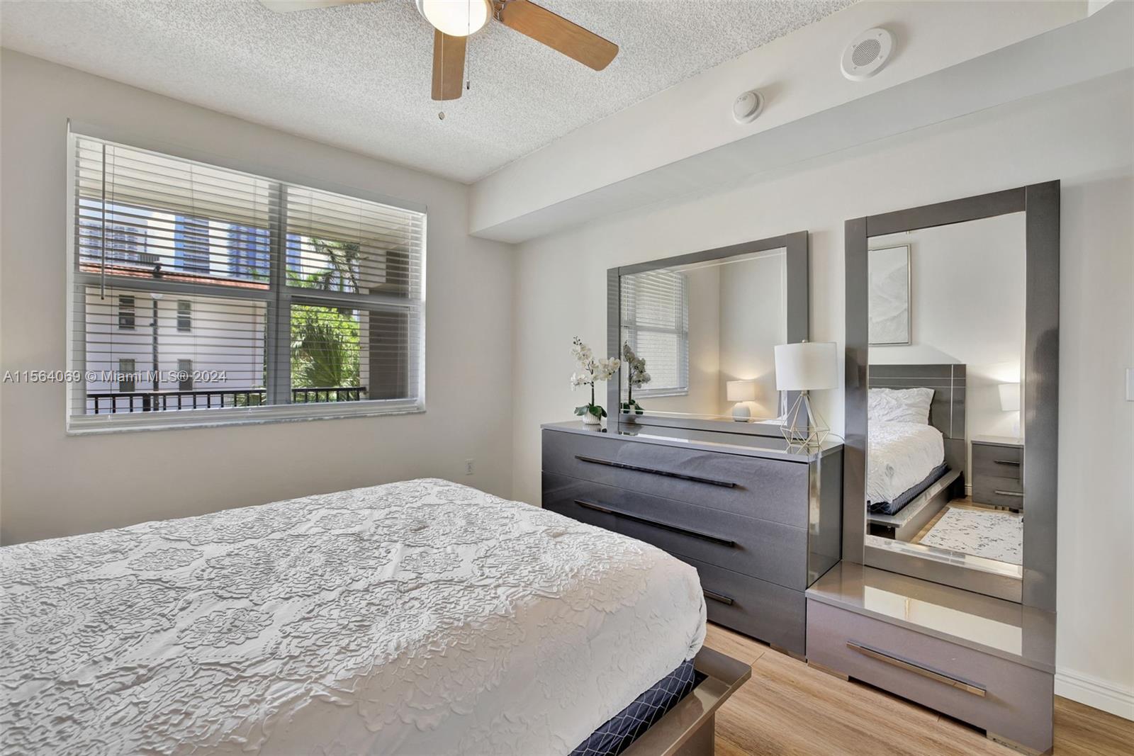 17150 North Bay Road, Unit 2216 Sunny Isles Beach, FL 33160 - Photo 20 of 46 a bedroom with a bed and a mirror