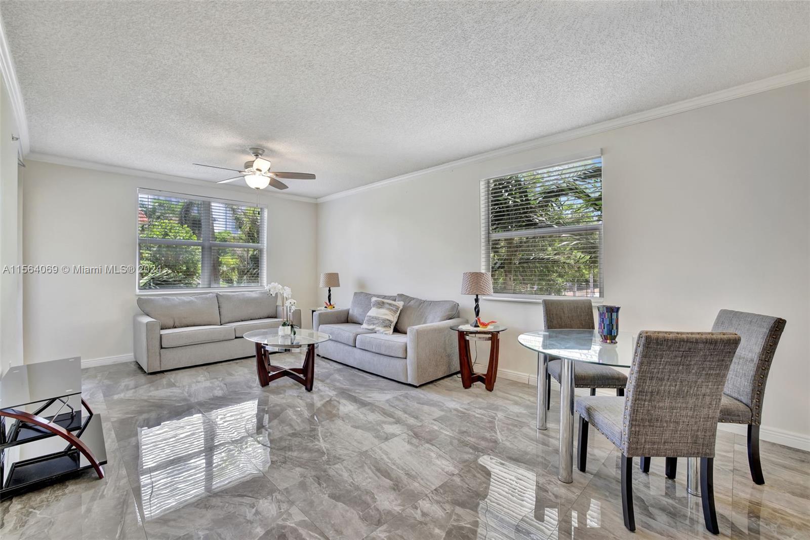 17150 North Bay Road, Unit 2216 Sunny Isles Beach, FL 33160 - Photo 2 of 46 a living room with furniture and a large window