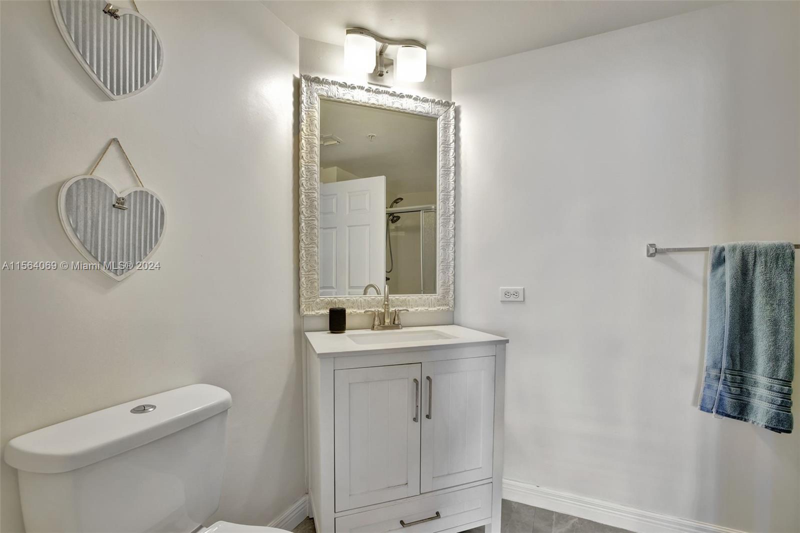 17150 North Bay Road, Unit 2216 Sunny Isles Beach, FL 33160 - Photo 22 of 46 a bathroom with a toilet sink and mirror