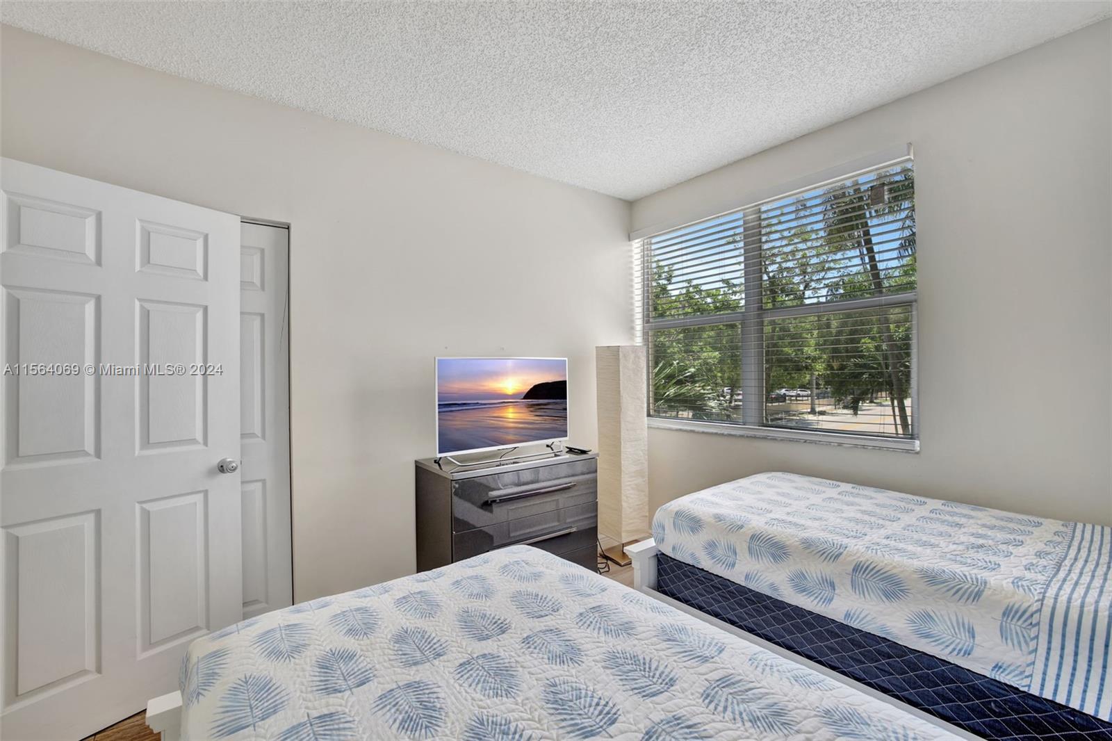 17150 North Bay Road, Unit 2216 Sunny Isles Beach, FL 33160 - Photo 28 of 46 a bedroom with a bed and a window