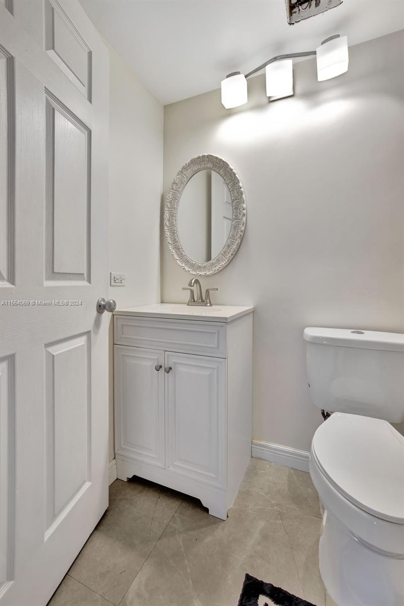 17150 North Bay Road, Unit 2216 Sunny Isles Beach, FL 33160 - Photo 31 of 46 a bathroom with a toilet a sink and a mirror