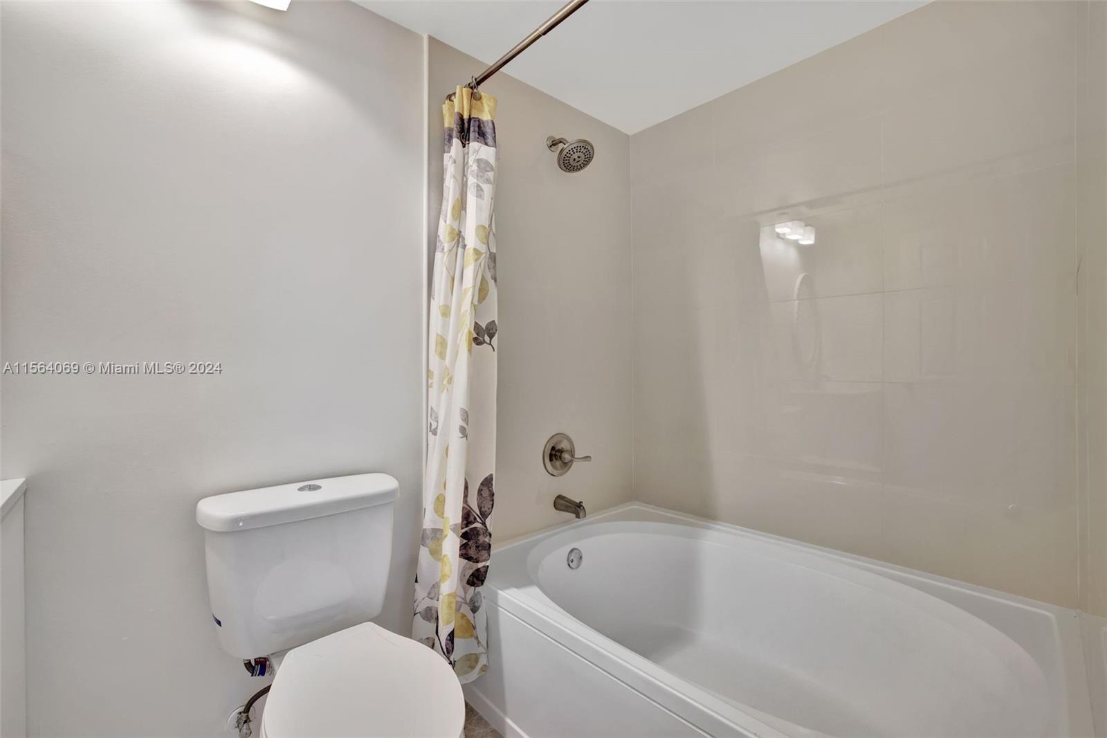 17150 North Bay Road, Unit 2216 Sunny Isles Beach, FL 33160 - Photo 32 of 46 a white toilet sitting next to a bath tub