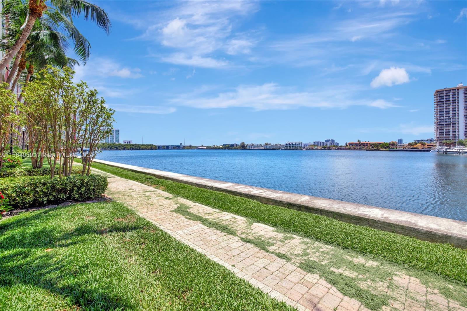 17150 North Bay Road, Unit 2216 Sunny Isles Beach, FL 33160 - Photo 36 of 46 a view of a lake with houses in the back