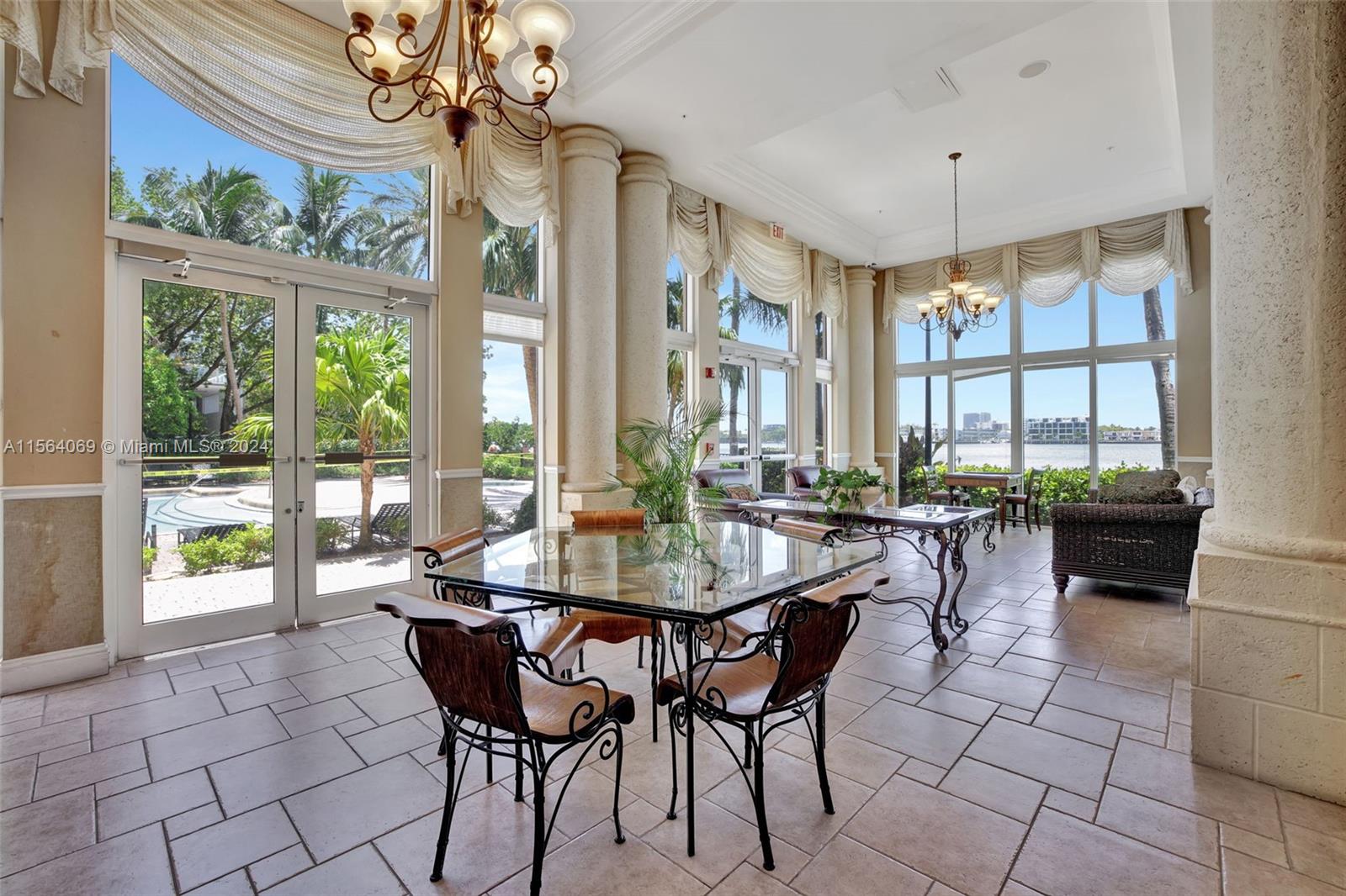 17150 North Bay Road, Unit 2216 Sunny Isles Beach, FL 33160 - Photo 39 of 46 a dining room with furniture a chandelier and wooden floor