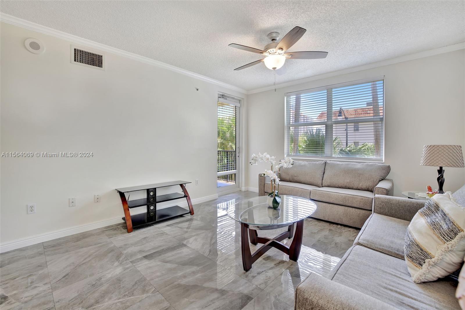 17150 North Bay Road, Unit 2216 Sunny Isles Beach, FL 33160 - Photo 4 of 46 a living room with furniture and a large window