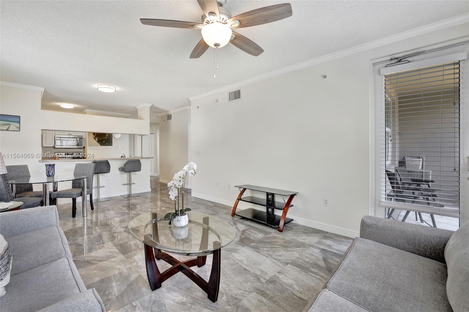 17150 North Bay Road, Unit 2216 Sunny Isles Beach, FL 33160 - Photo 5 of 46 a living room with furniture and a window