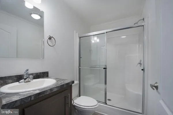 a bathroom with a granite countertop sink toilet a mirror and shower