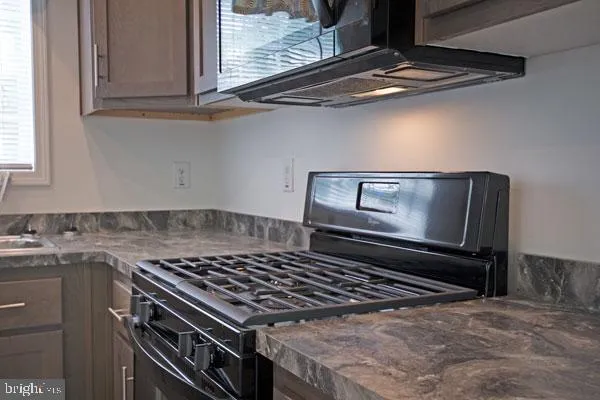 a stove top oven sitting inside of a kitchen