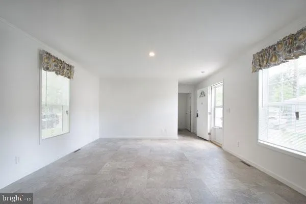 a view of an empty room with a window