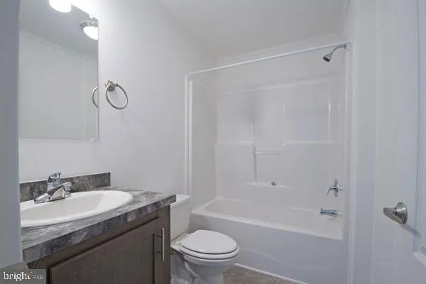 a bathroom with a granite countertop sink a toilet and shower
