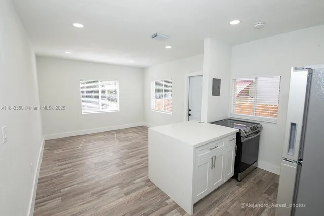 a kitchen with a stove a sink and a refrigerator