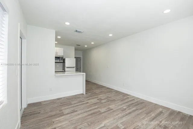 a view of kitchen and wooden floor