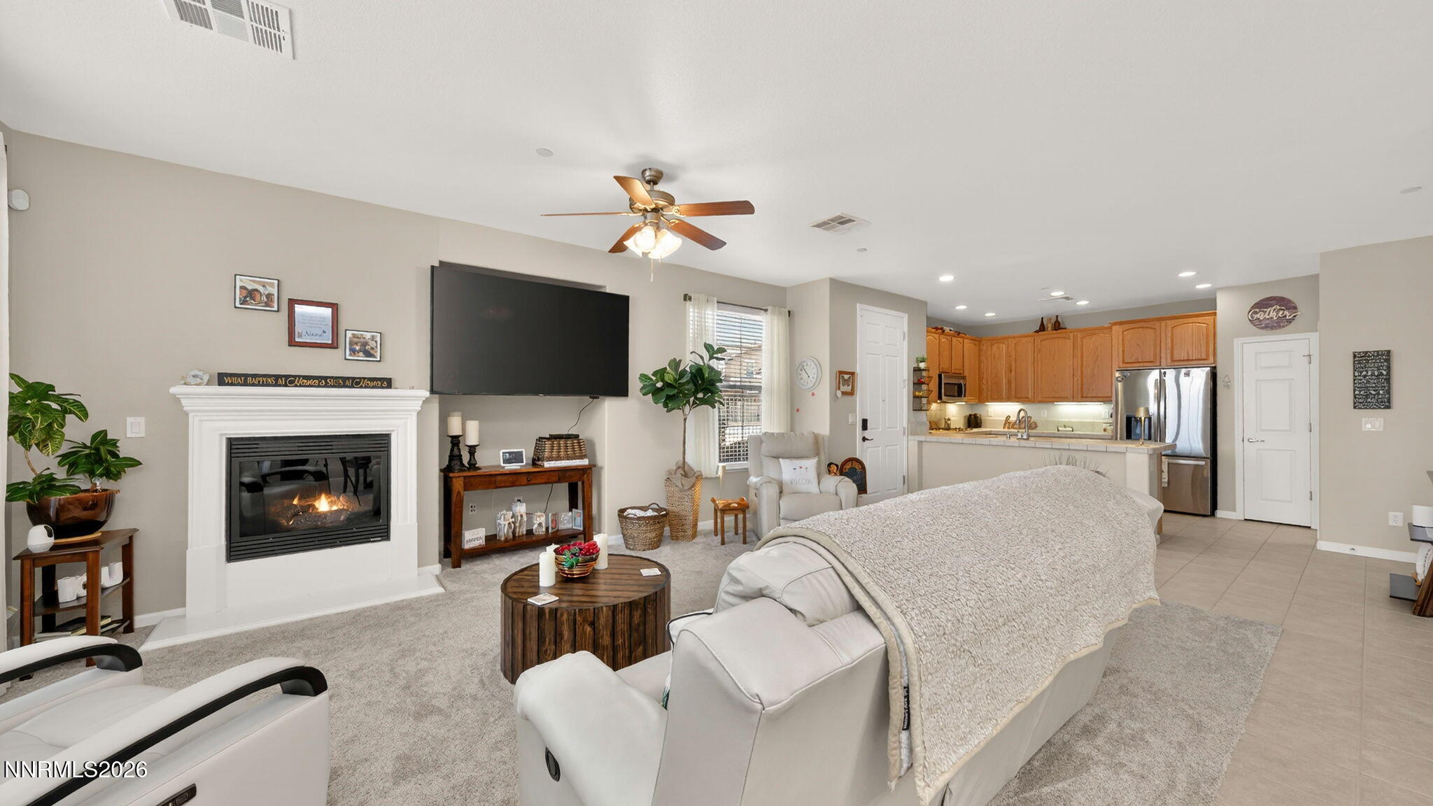 1750 Wind Ranch Road, Unit B Reno, NV 89521 - Photo 11 of 42 a living room with furniture a fireplace and a flat screen tv