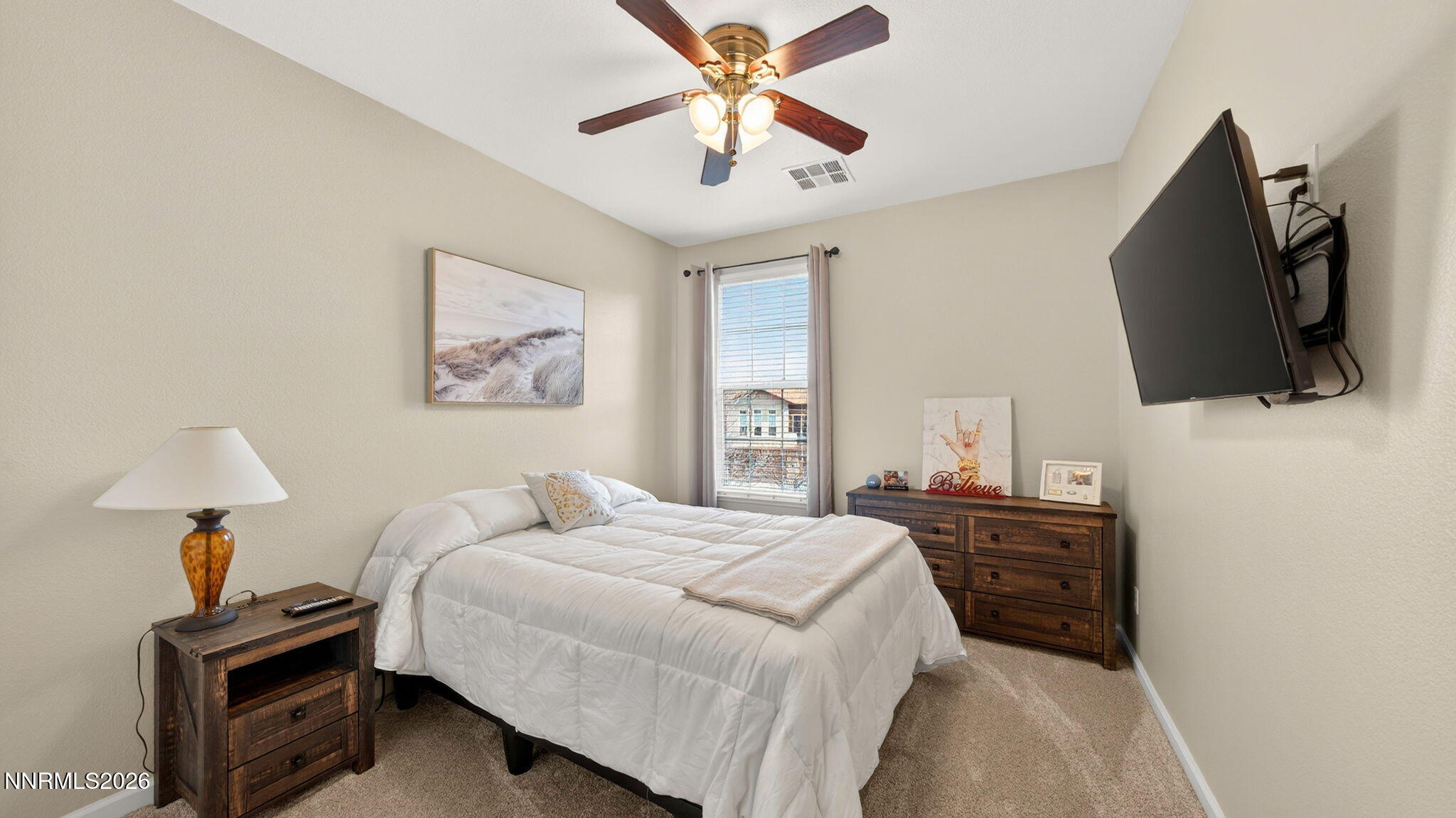 1750 Wind Ranch Road, Unit B Reno, NV 89521 - Photo 21 of 42 a bedroom with a bed and a flat screen tv