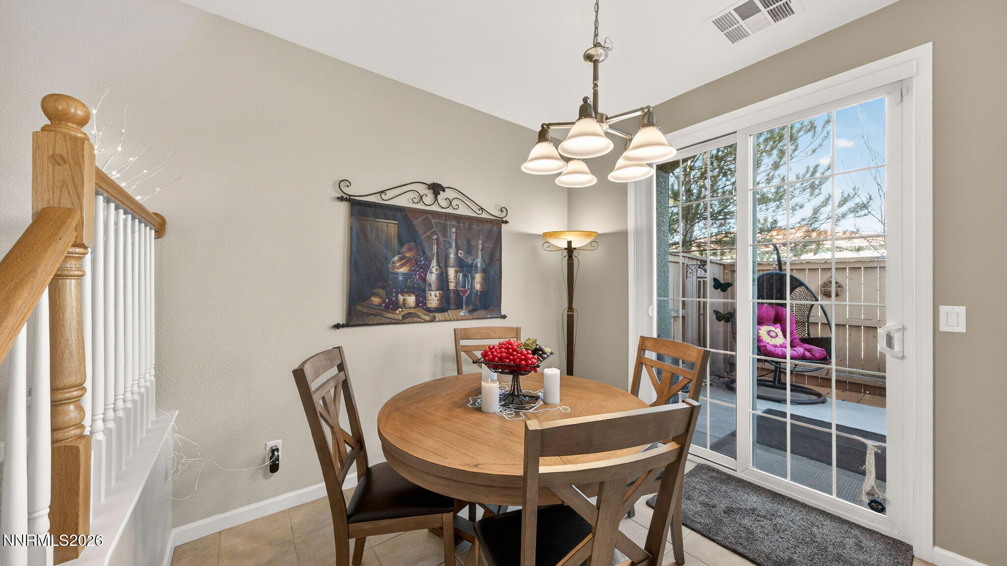 1750 Wind Ranch Road, Unit B Reno, NV 89521 - Photo 22 of 42 a view of a dining room with furniture wooden floor and chandelier