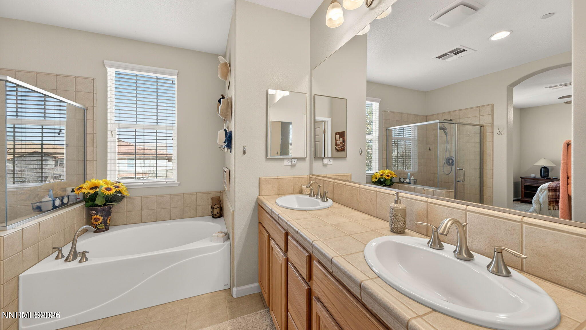 1750 Wind Ranch Road, Unit B Reno, NV 89521 - Photo 27 of 42 a bathroom with a sink double vanity granite tub shower and a mirror