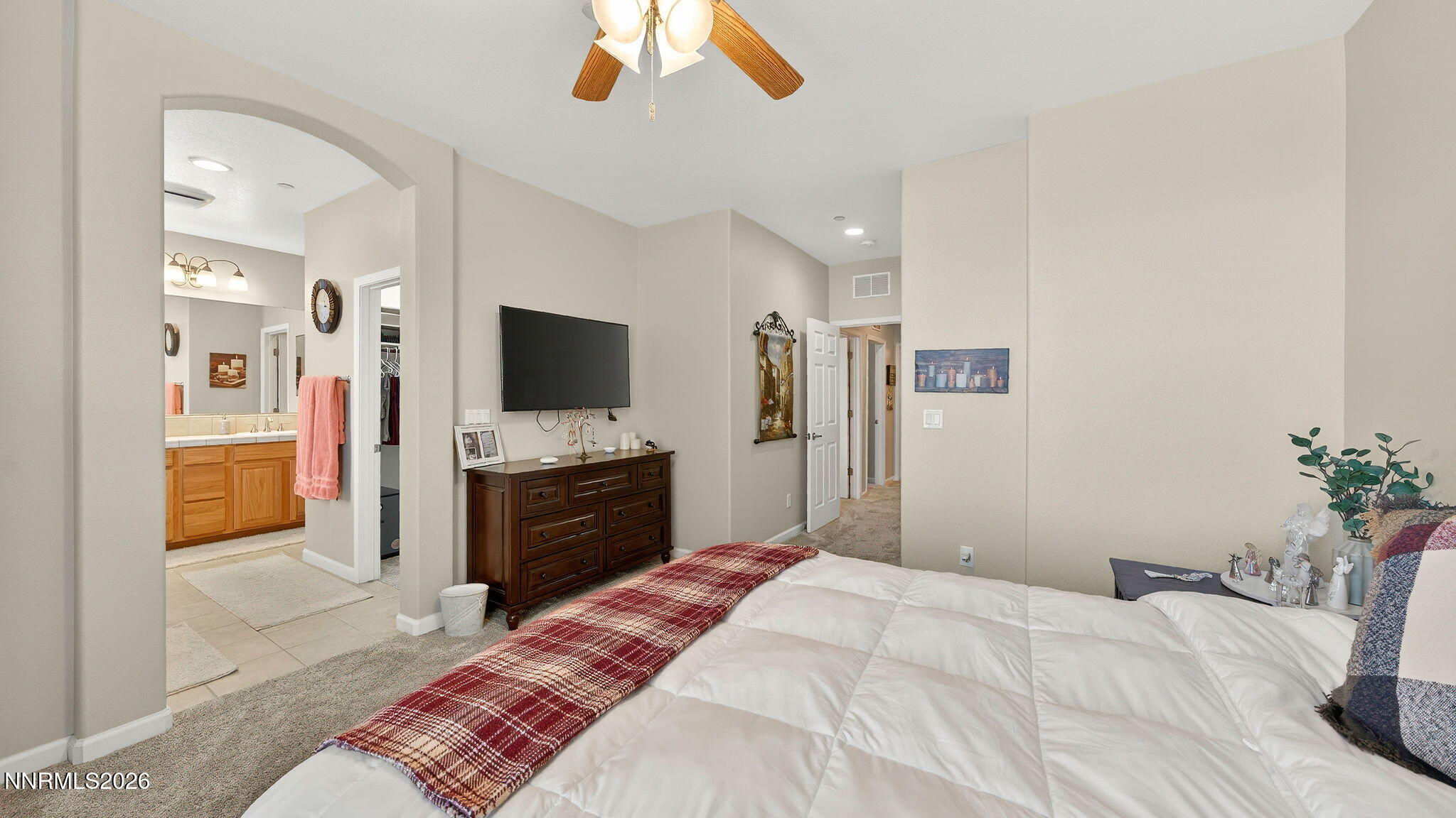 1750 Wind Ranch Road, Unit B Reno, NV 89521 - Photo 28 of 42 a bedroom with a bed and a flat screen tv