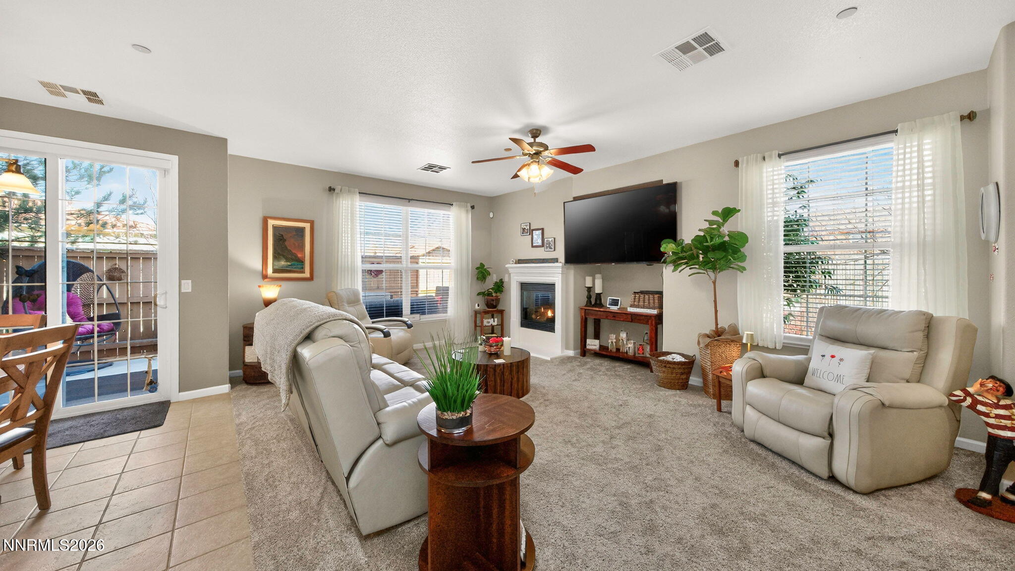 1750 Wind Ranch Road, Unit B Reno, NV 89521 - Photo 7 of 42 a living room with furniture a fireplace and a flat screen tv