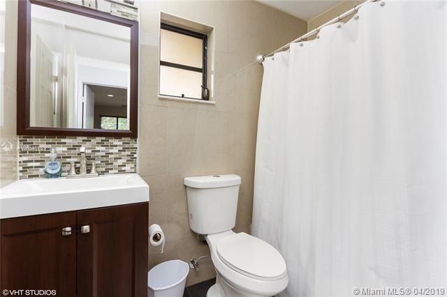 7610 Northwest 79th Avenue, Unit I5 Fort Lauderdale, FL 33321 - Photo 11 of 22 a bathroom with a toilet a sink and a mirror