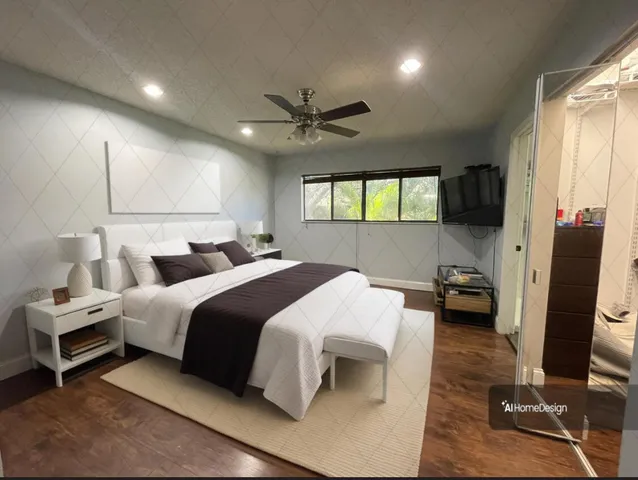 a bedroom with a bed and a large window