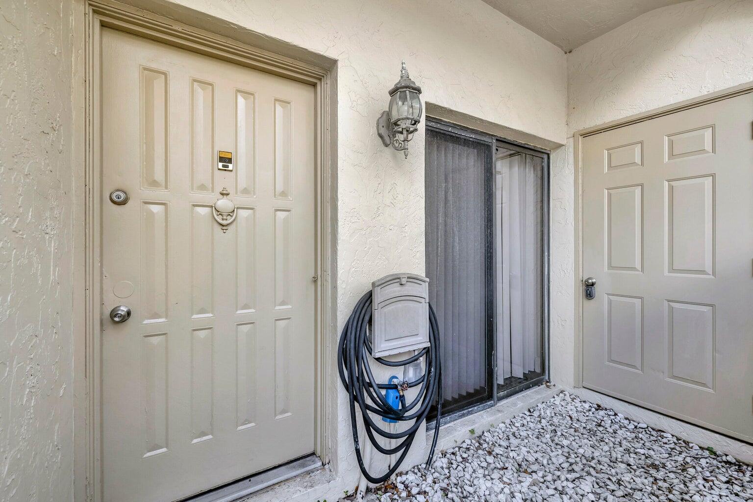 7610 Northwest 79th Avenue, Unit I5 Fort Lauderdale, FL 33321 - Photo 2 of 22 a view of a hallway with painted walls
