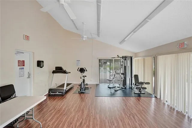 a view of a workspace with furniture and wooden floor