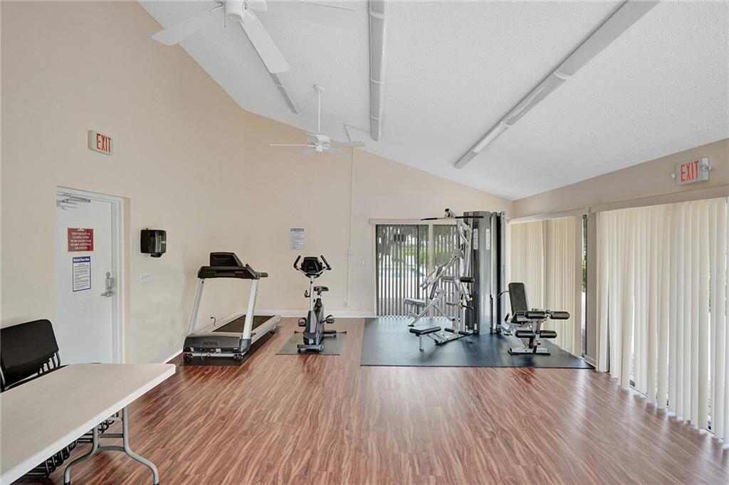 7610 Northwest 79th Avenue, Unit I5 Fort Lauderdale, FL 33321 - Photo 21 of 22 a view of a workspace with furniture and wooden floor