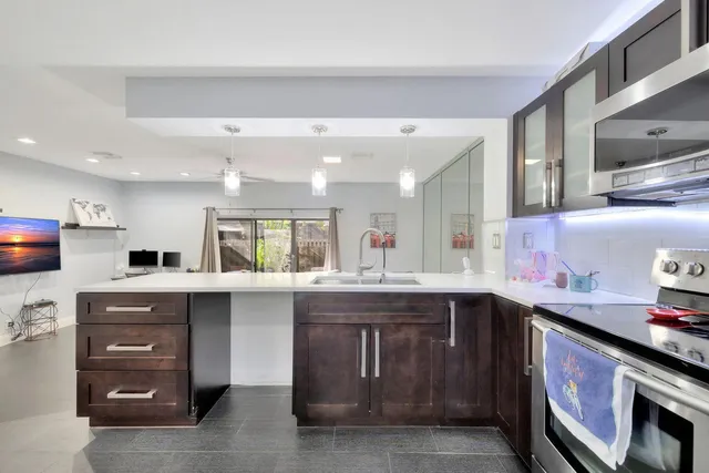 a kitchen with a sink stove and cabinets