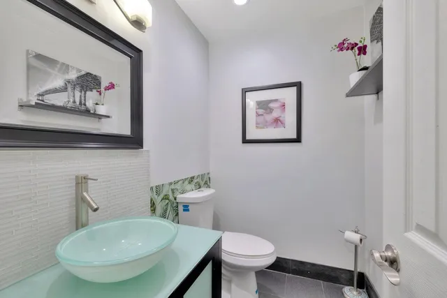 a bathroom with a toilet a sink and a mirror