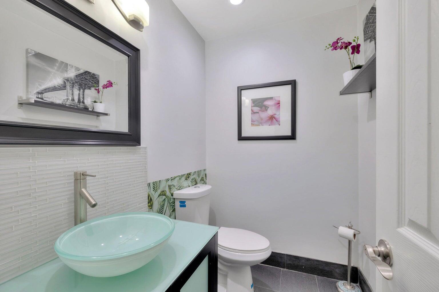 7610 Northwest 79th Avenue, Unit I5 Fort Lauderdale, FL 33321 - Photo 7 of 22 a bathroom with a toilet a sink and a mirror