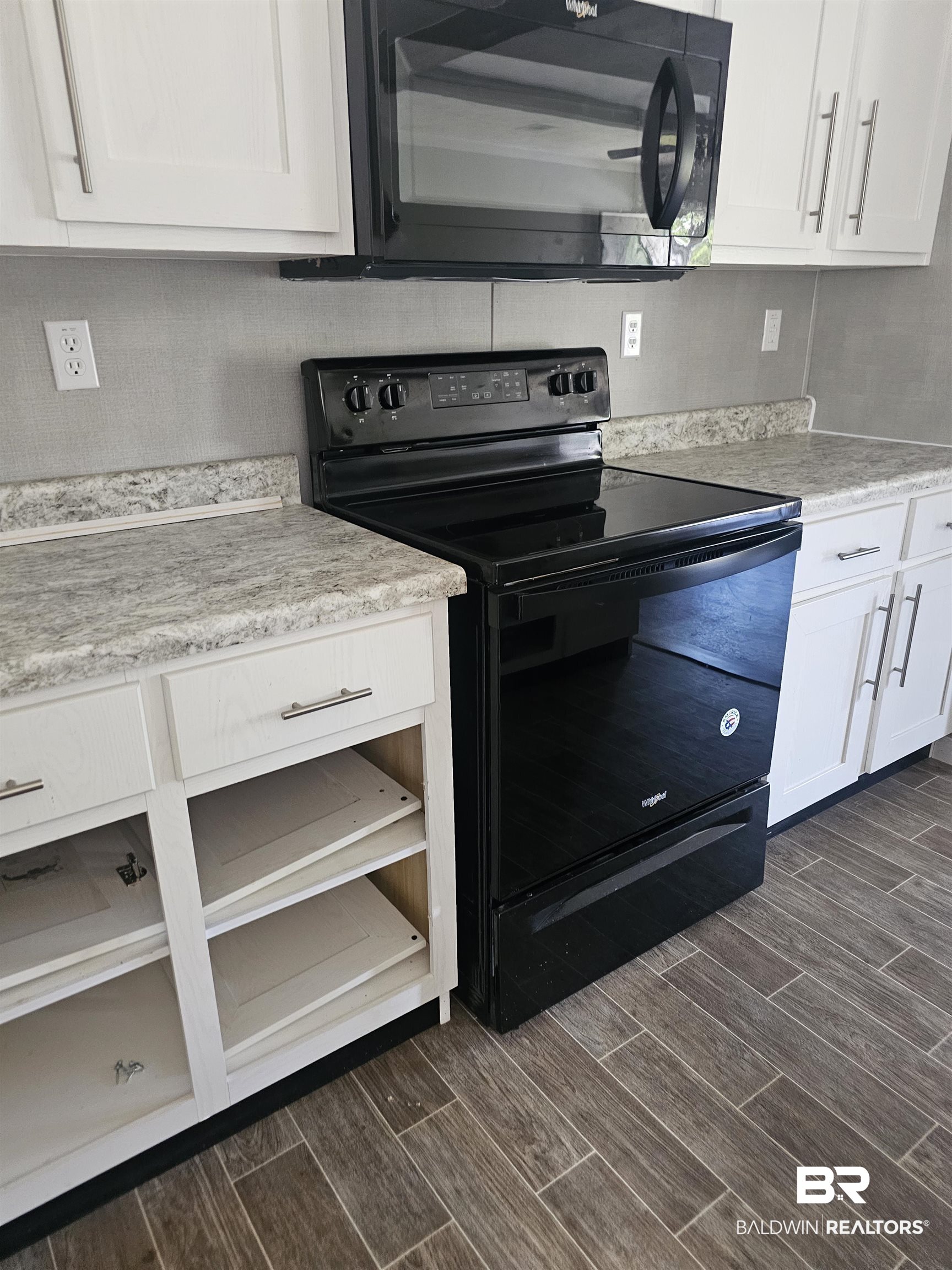 1863 Wait Road Monroeville, AL 36460 - Photo 25 of 38 Kitchen featuring white cabinetry and black appliances