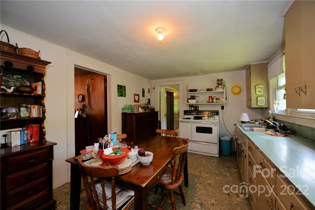826 Monteith Branch Road Sylva, NC 28779 - Photo 13 of 14 a view of a dining room with furniture and a kitchen
