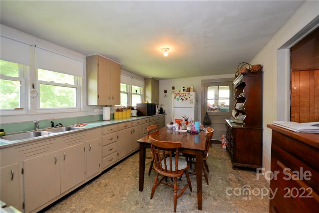 826 Monteith Branch Road Sylva, NC 28779 - Photo 14 of 14 a kitchen with granite countertop sink table and chairs