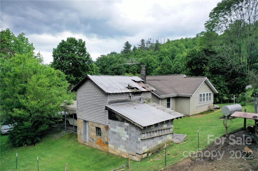 826 Monteith Branch Road Sylva, NC 28779 - Photo 5 of 14 a aerial view of a house with a yard table and chairs