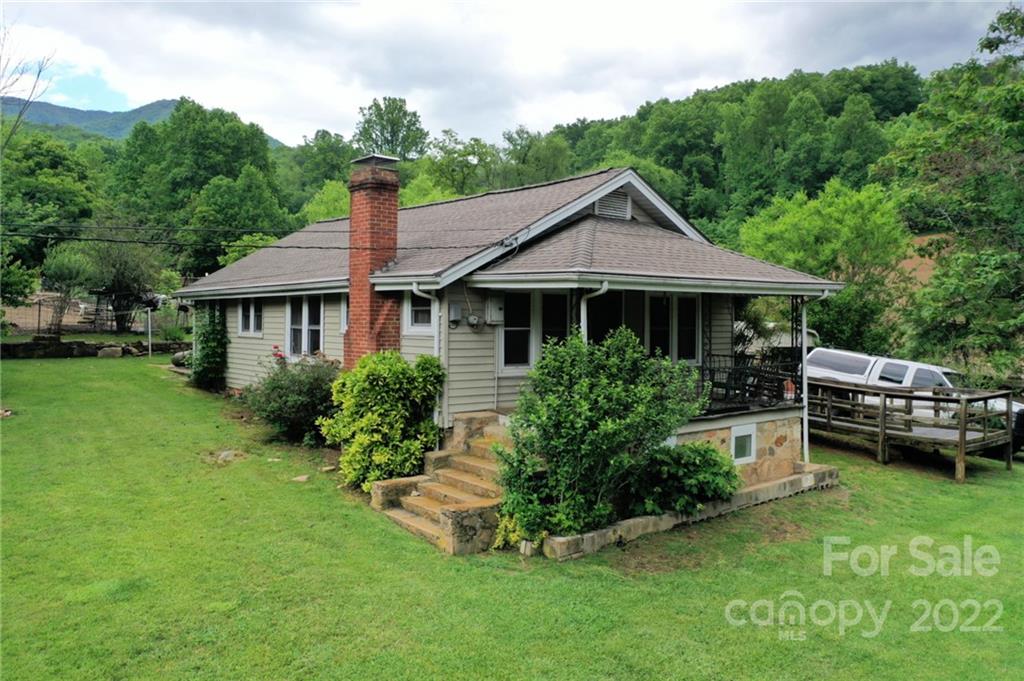 826 Monteith Branch Road Sylva, NC 28779 - Photo 6 of 14 a front view of a house with a garden