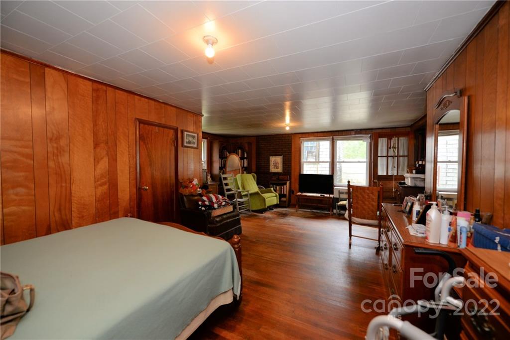 826 Monteith Branch Road Sylva, NC 28779 - Photo 8 of 14 a bed room with furniture and wooden floor