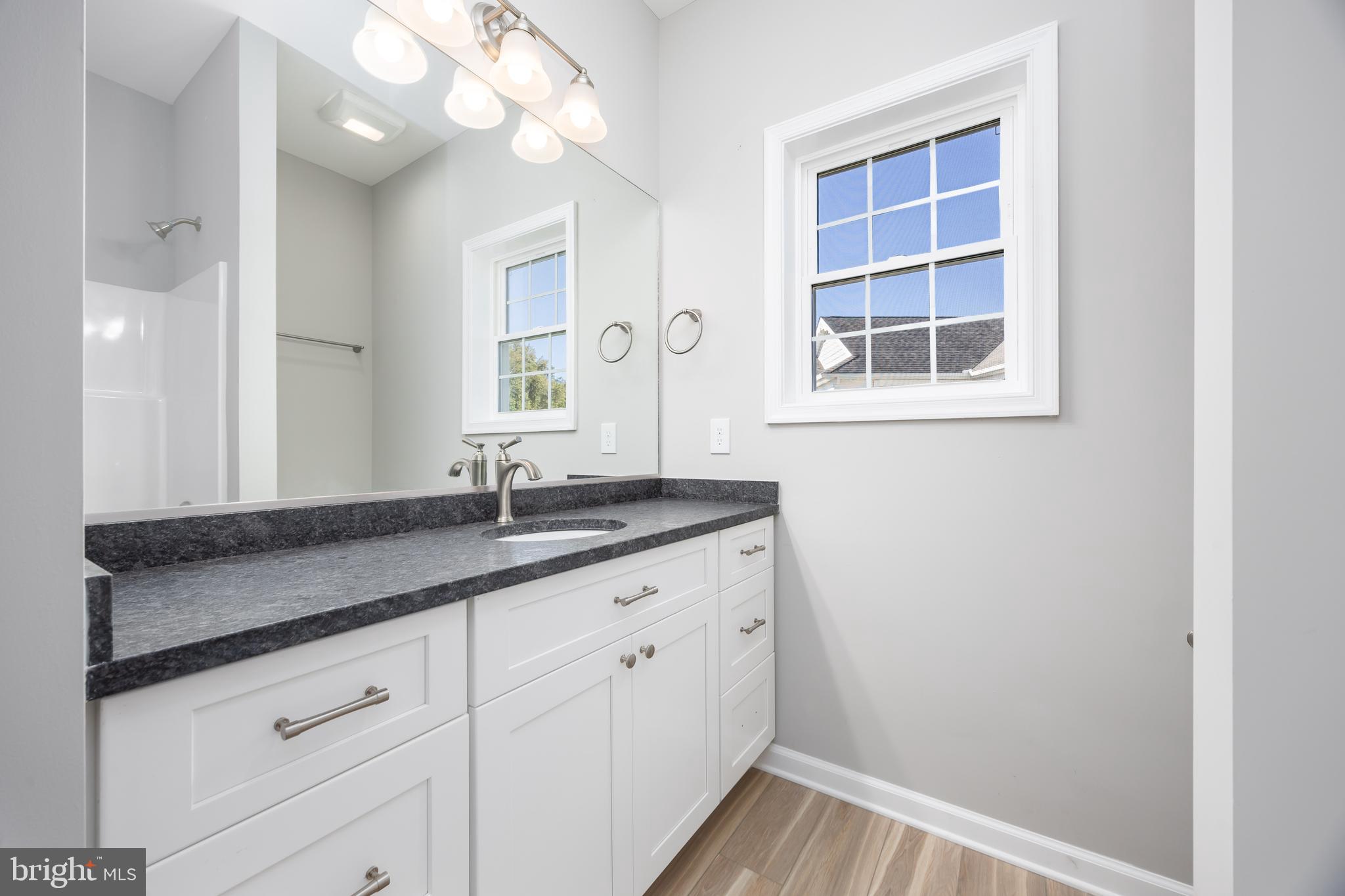 11779 St Stephens Way Princess Anne, MD 21853 - Photo 36 of 51 a bathroom with a granite countertop sink and a mirror