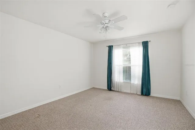 a spacious bathroom with a granite countertop sink a mirror and a vanity
