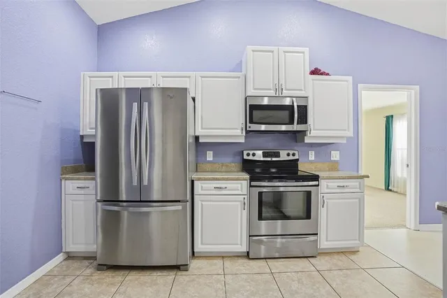 an empty room with a ceiling fan and a window