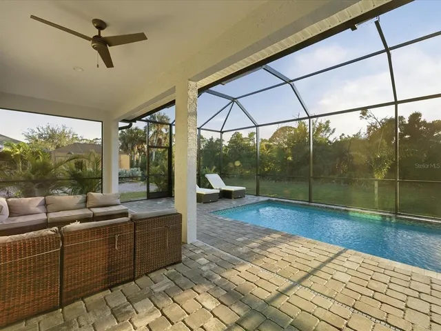 a living room with furniture and large windows