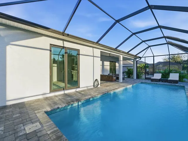 a view of a roof deck with couches and umbrella