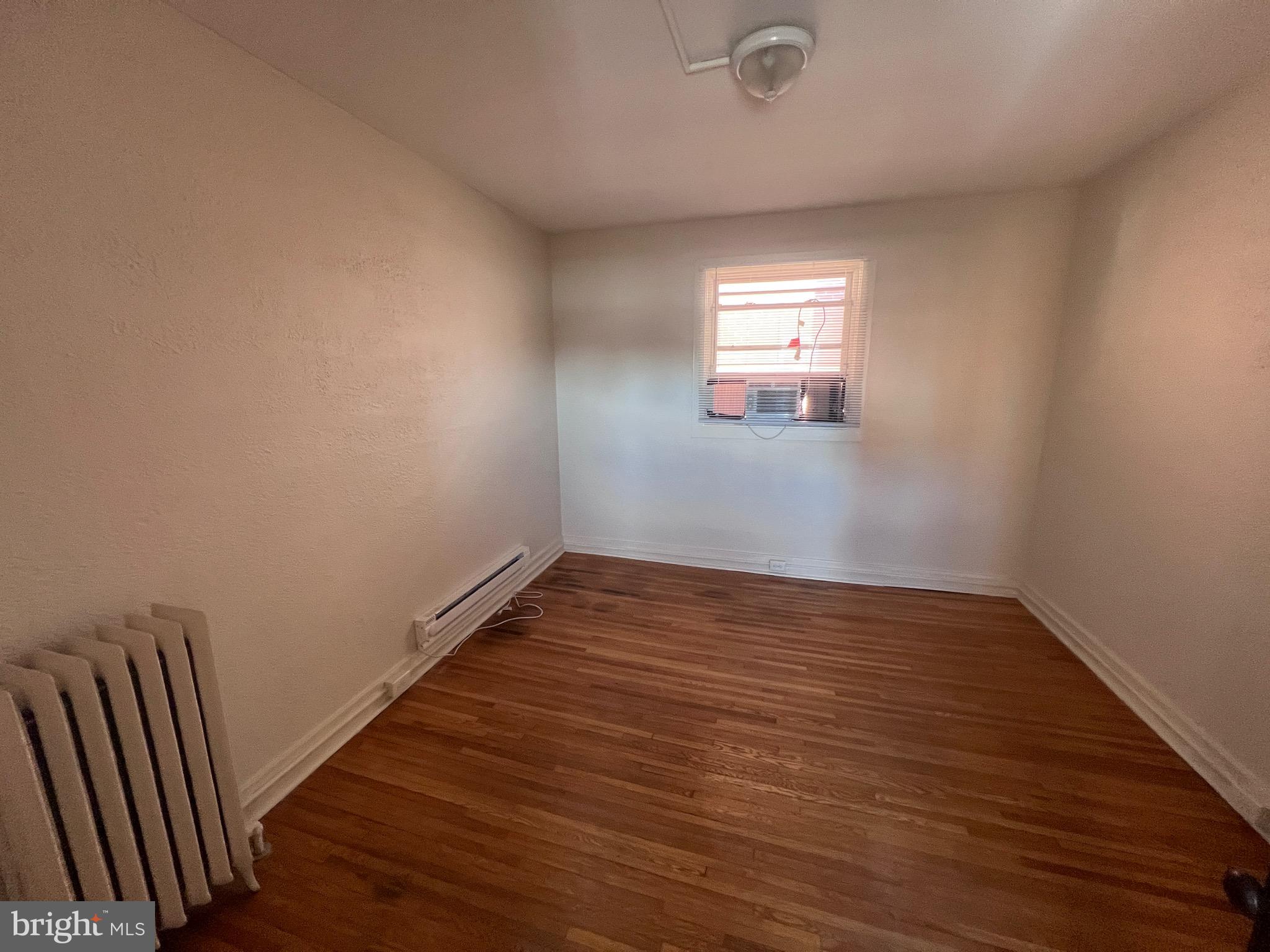144 West Patrick Street, Unit 4 Frederick, MD 21701 - Photo 13 of 16 a view of an empty room with wooden floor and a window