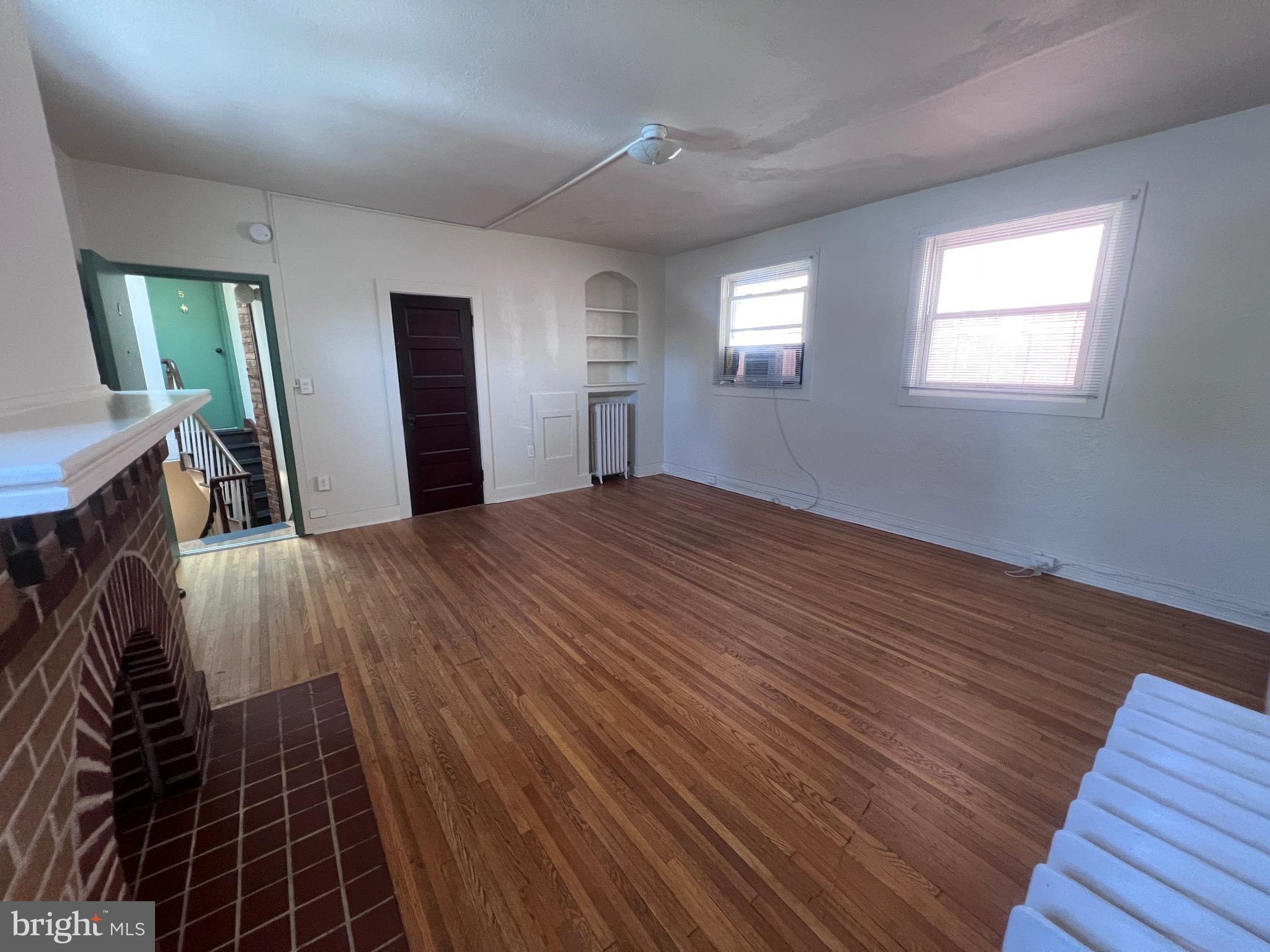 144 West Patrick Street, Unit 4 Frederick, MD 21701 - Photo 6 of 16 a view of an empty room with wooden floor and a window