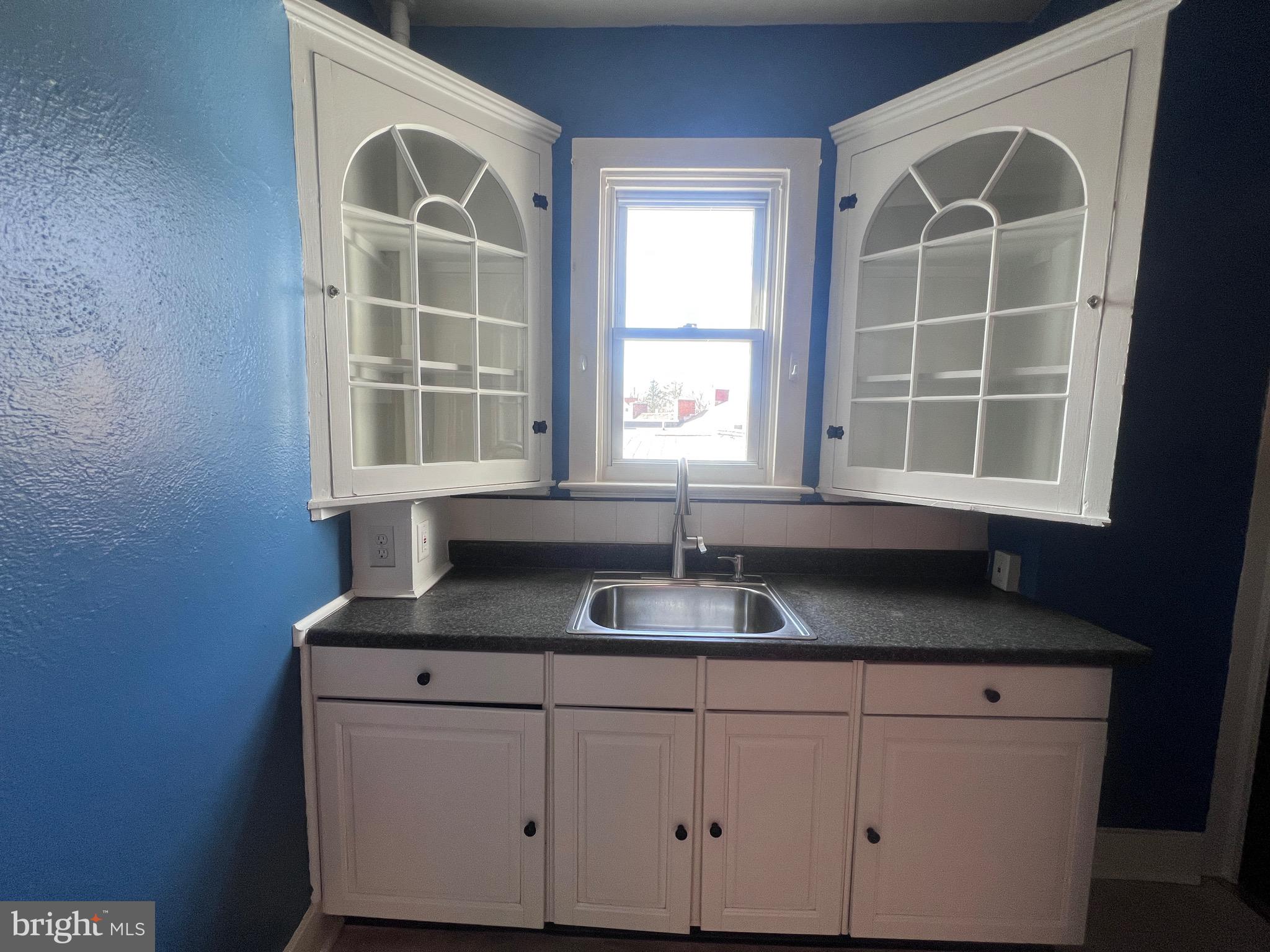 144 West Patrick Street, Unit 4 Frederick, MD 21701 - Photo 8 of 16 a kitchen with granite countertop cabinets and window