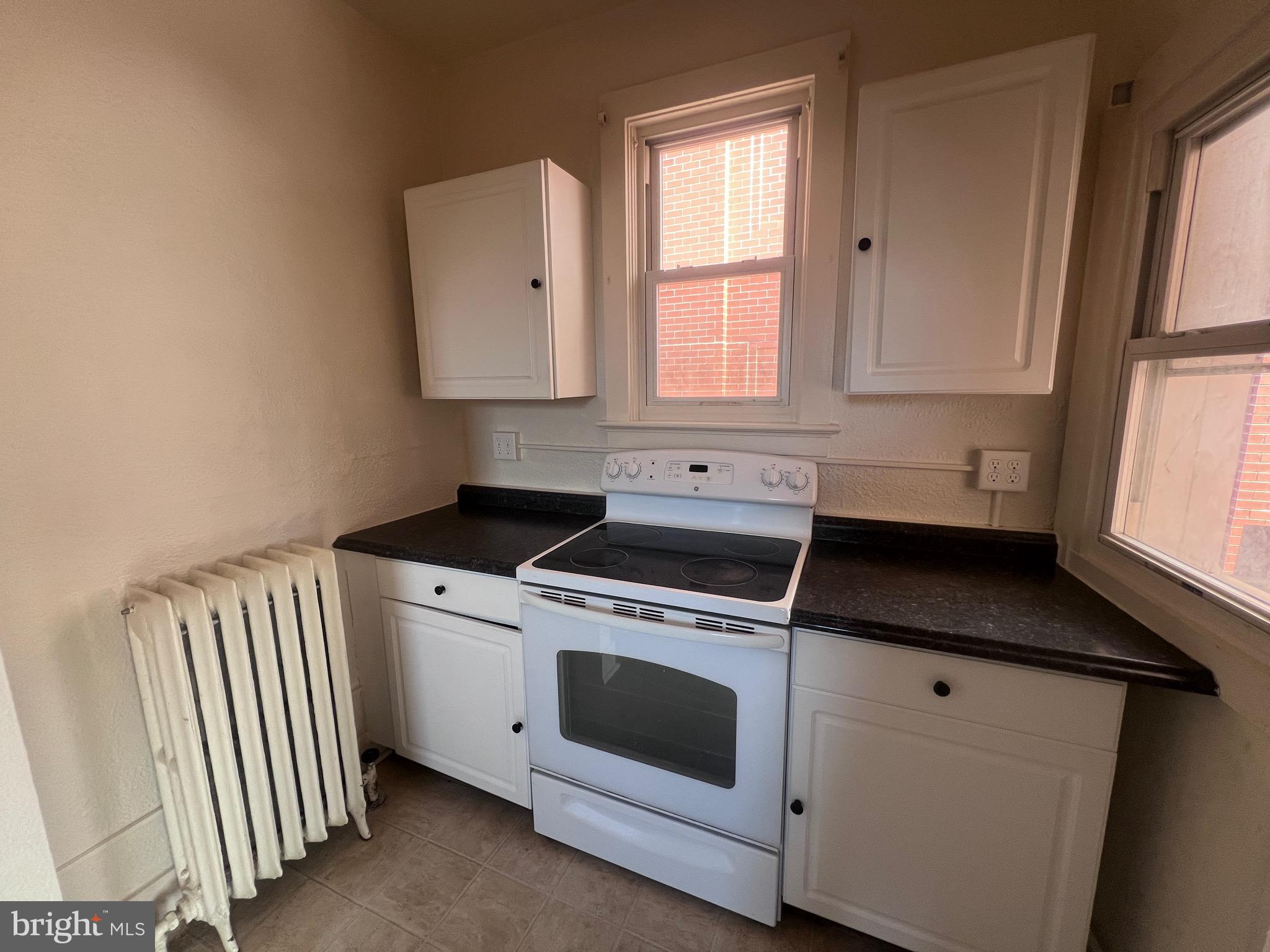 144 West Patrick Street, Unit 4 Frederick, MD 21701 - Photo 9 of 16 a kitchen with white cabinets and white appliances