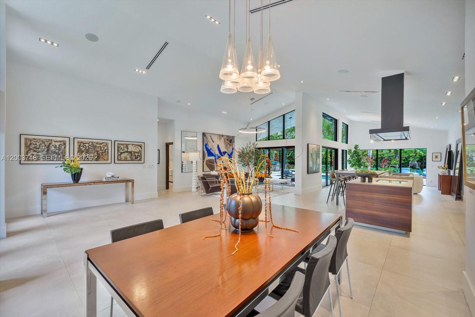 2675 Hackney Road Weston, FL 33331 - Photo 20 of 61 a view of a dining room with furniture a chandelier and wooden floor