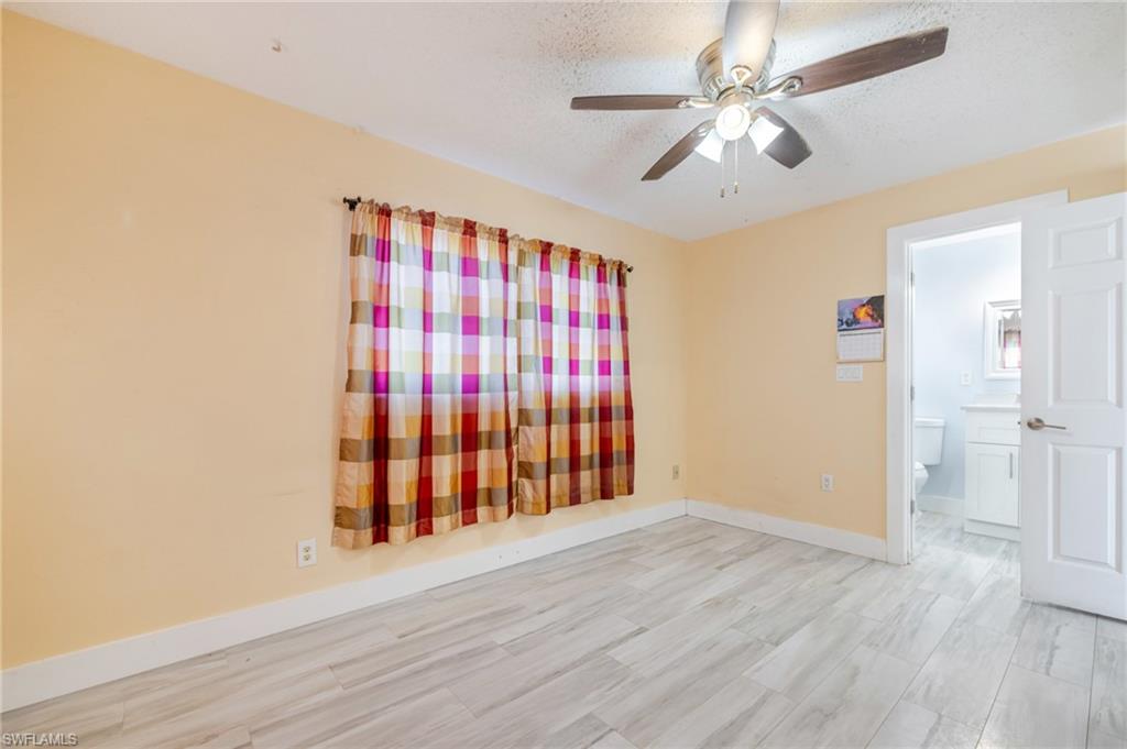 339 Beachwood Road Lehigh Acres, FL 33936 - Photo 16 of 32 Spare room with a textured ceiling, wood finished floors, and a ceiling fan